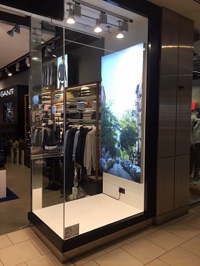 One side of the GANT Lakeside storefront showing LED light box in widow display